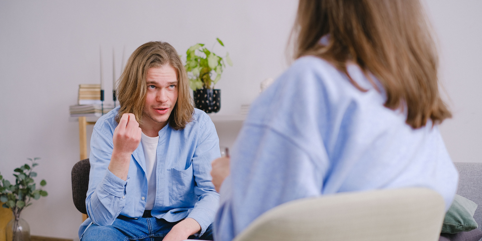A person speaking with a support professional during a private conversation in a comfortable office setting.