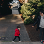 National Recovery Month and Elijah Family Homes logos above a mother and young child walking through a residential neighborhood.